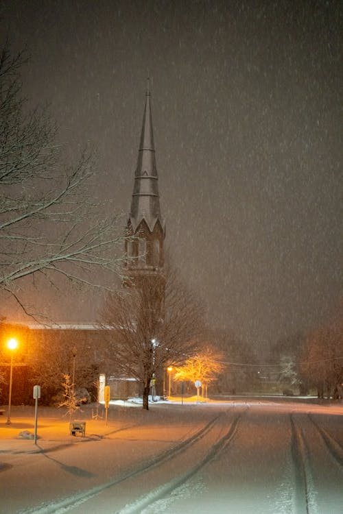 A church steeple is seen in the snow