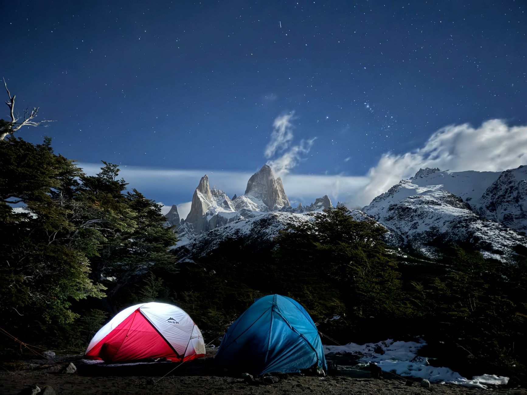backpacker sleeping under stars wilderness