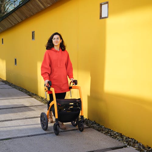Young woman walking with a modern mobility aid