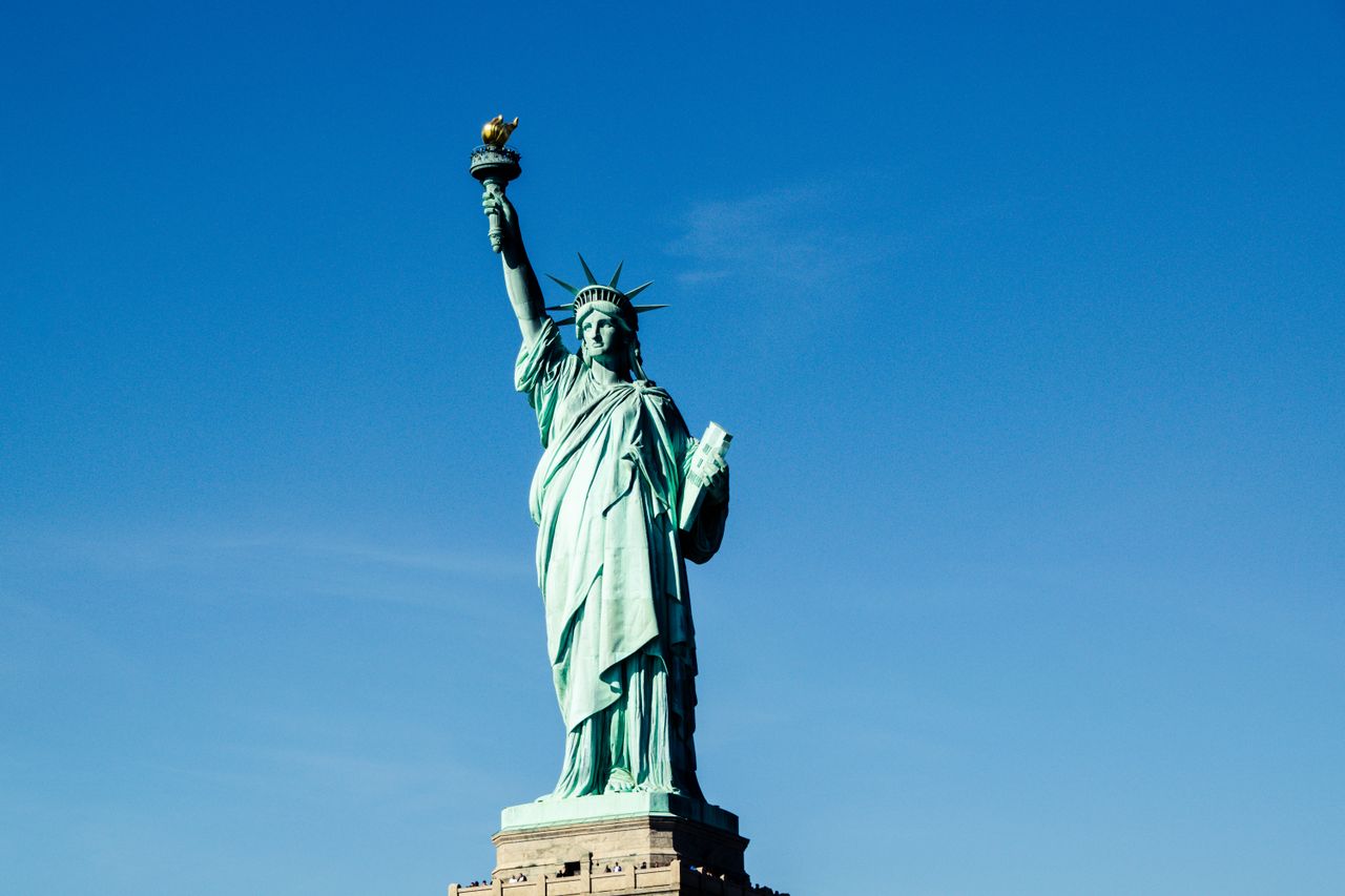 iconic statue of liberty with vibrant blue sky backdrop symbolizing fr