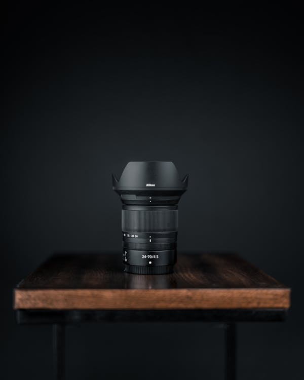 Free Black Camera Zoom Lens on Wooden Table Stock Photo