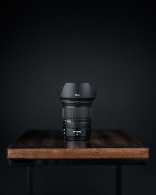 Free Black Camera Zoom Lens on Wooden Table Stock Photo