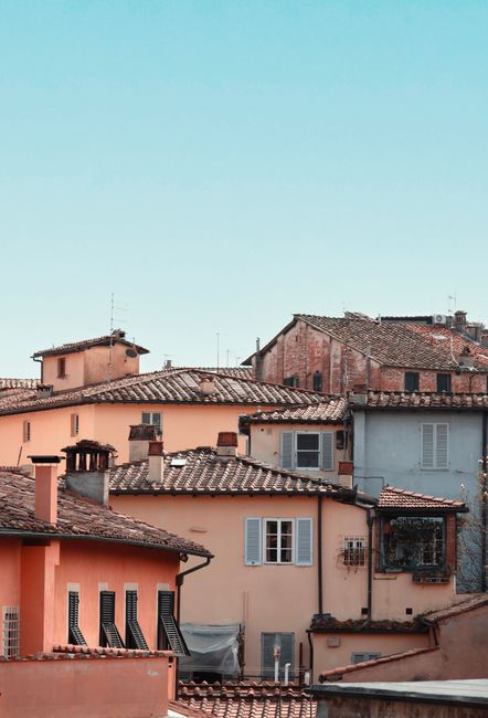 Charming urban landscape of Lucca, Italy, showcasing classic Tuscan architecture and tiled roofs.