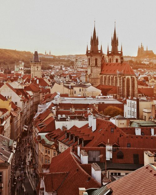 Free A captivating view of Prague's Old Town featuring Gothic architecture under the warm dusk light. Stock Photo