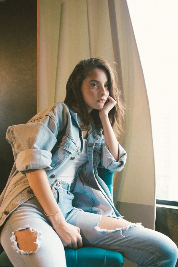 Woman in layered casual outfit with jeans