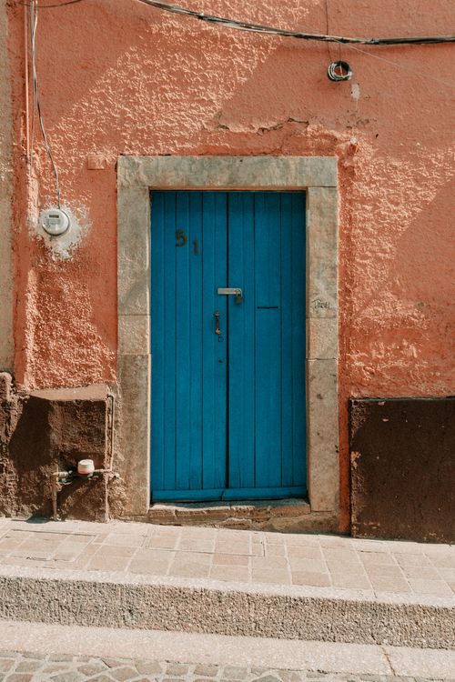 Free Colorful blue door on a rustic street in Guanajuato, Mexico highlighting local architecture. Stock Photo