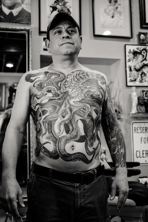 Man Standing and Showing His Body Tattoo