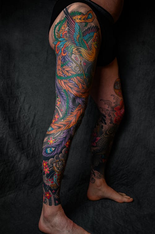 Free Person With Floral Leg Tattoo Standing Stock Photo