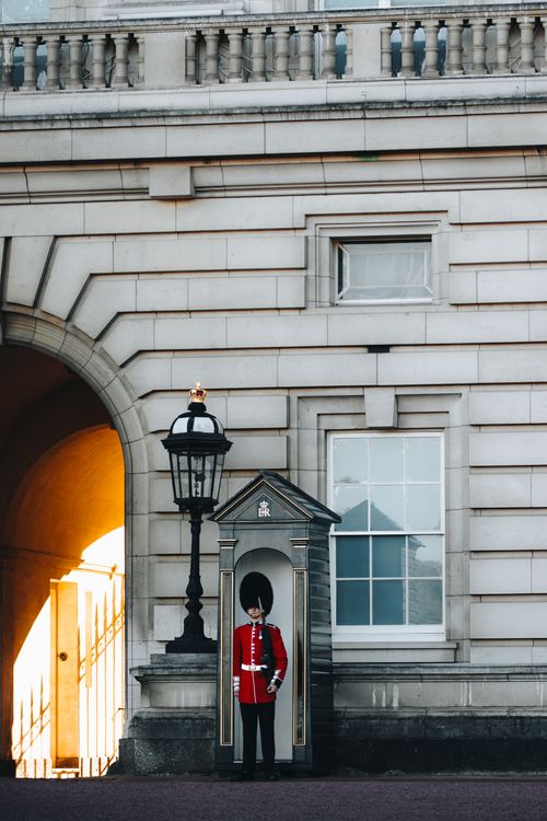 Free Iconic Buckingham Palace guard standing at attention in London, UK. Stock Photo