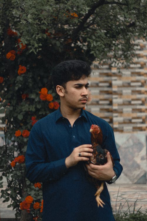 a boy holding cock 