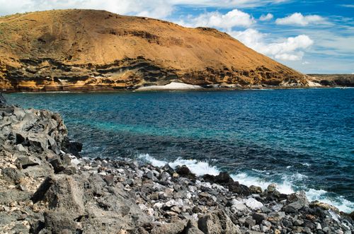 Free Explore the beautiful rocky coastline and clear blue waters of Tenerife, Spain's stunning landscape. Stock Photo