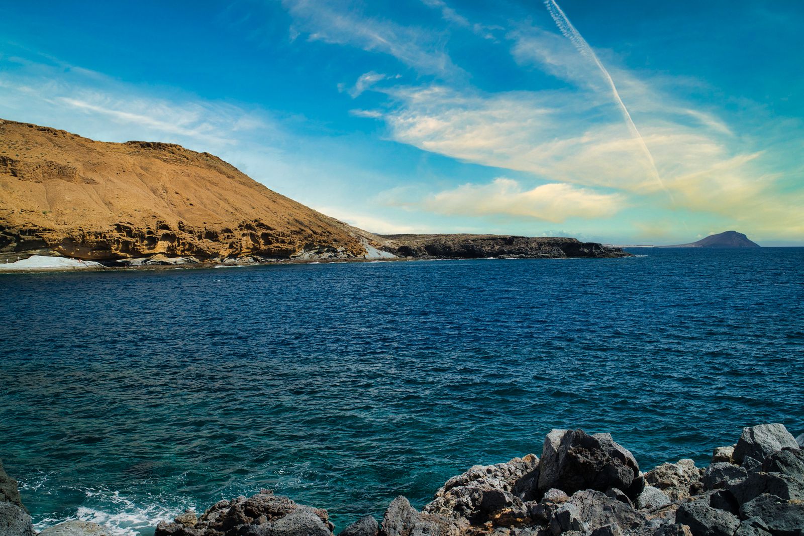 The crater edge goes orange before the harbour does