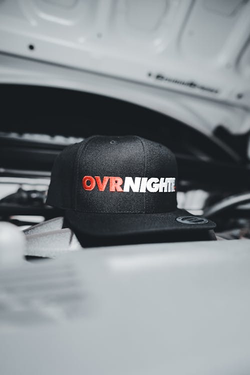 A hat with the word over night on it