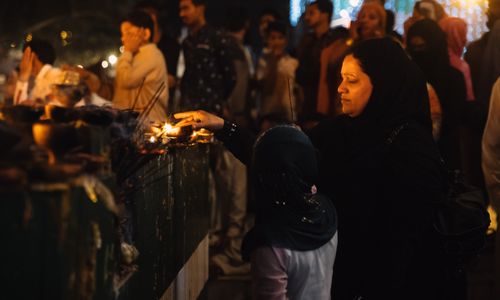 Free A woman partakes in a candle lighting ceremony during a cultural event in Lahore. Stock Photo