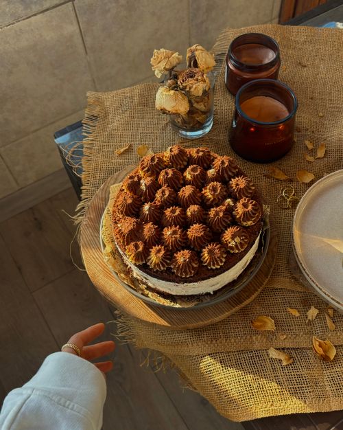 Free Top view of a rustic chocolate cake surrounded by coffee elements on a burlap tablecloth. Stock Photo
