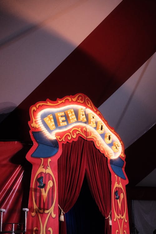 A circus tent with a red curtain and a red curtain