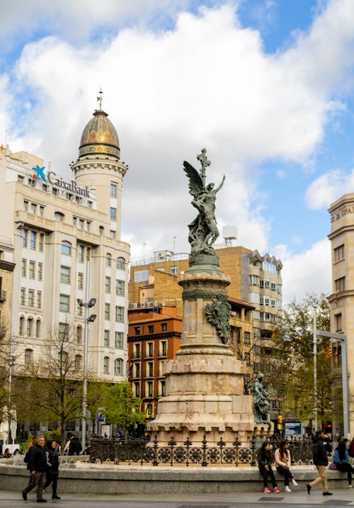 A statue of a man in front of buildings