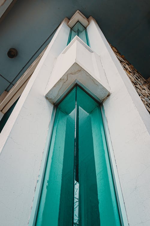 A close up of a building with green glass