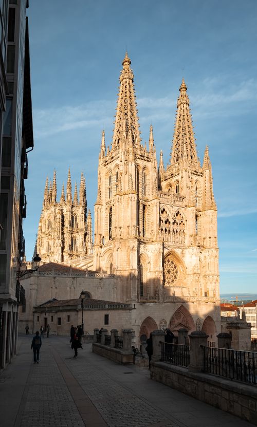 Free Burgos Cathedral, a Gothic landmark in Spain, captured during a vibrant sunset, showcasing its intricate architecture and urban setting. Stock Photo