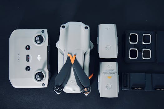 Top view of a drone with accessories neatly arranged on a dark surface.