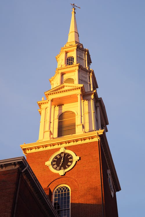 A tall steeple with a clock on top