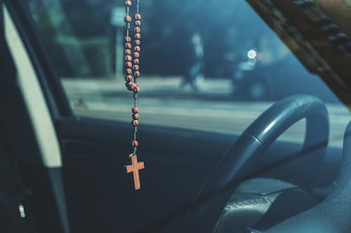 Free Brown Rosary Dangling on Car's Rear View Mirror Stock Photo