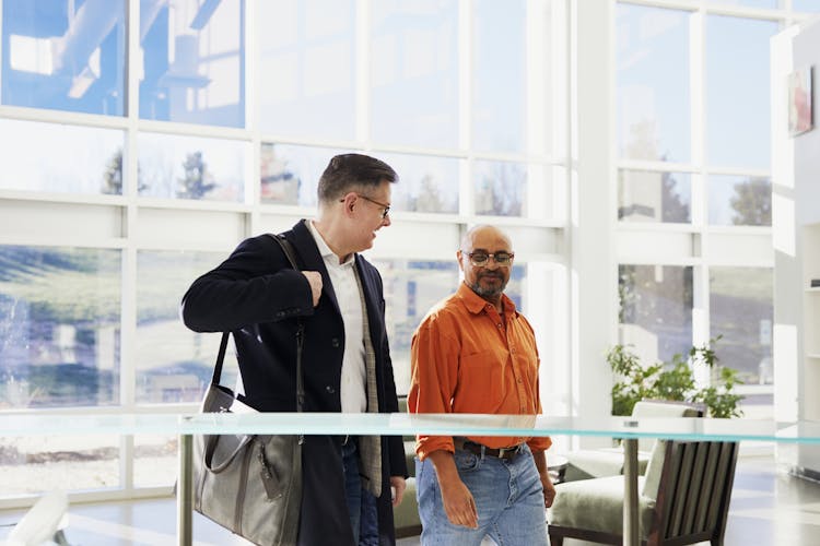 Two Men Walking Inside Building