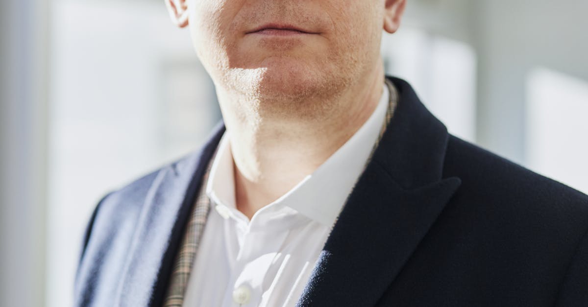 Profile portrait of a confident business executive wearing eyeglasses in a sunlit office setting. Local SEO