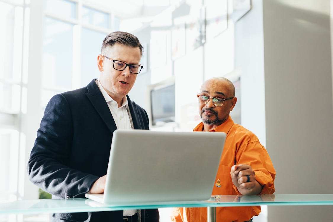Free Man Using Silver Laptop Beside Another Man Stock Photo