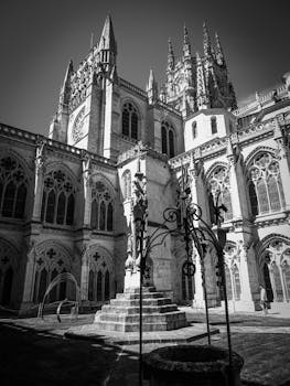 Black and white photo of the iconic Burgos Cathedral showcasing its gothic architecture.