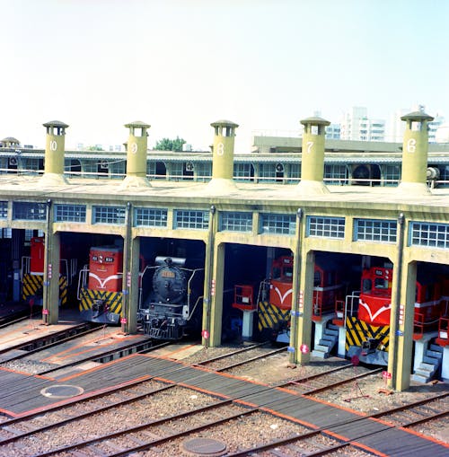 A train station with several trains parked in the station