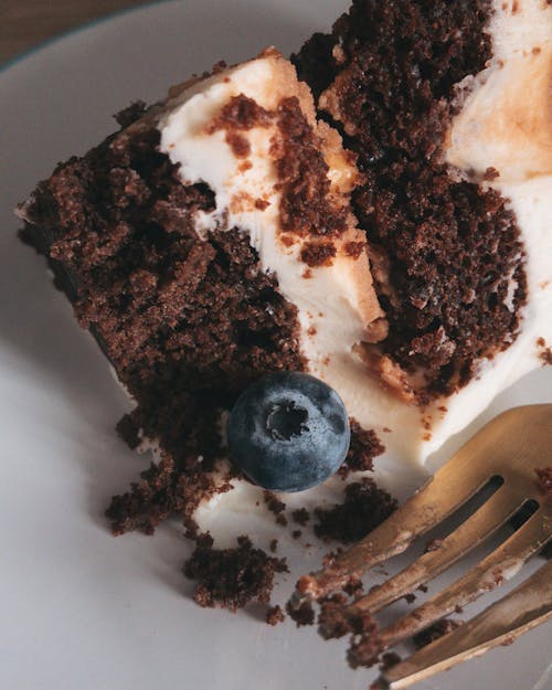 A slice of cake with blueberries on top