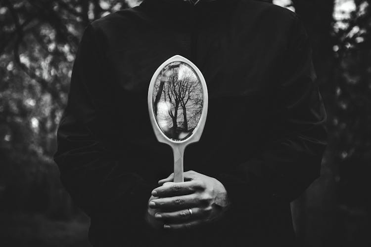 Person Holding Hand Mirror