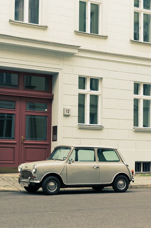 A small car parked in front of a building