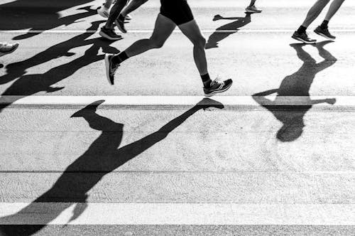 A black and white photo of people running