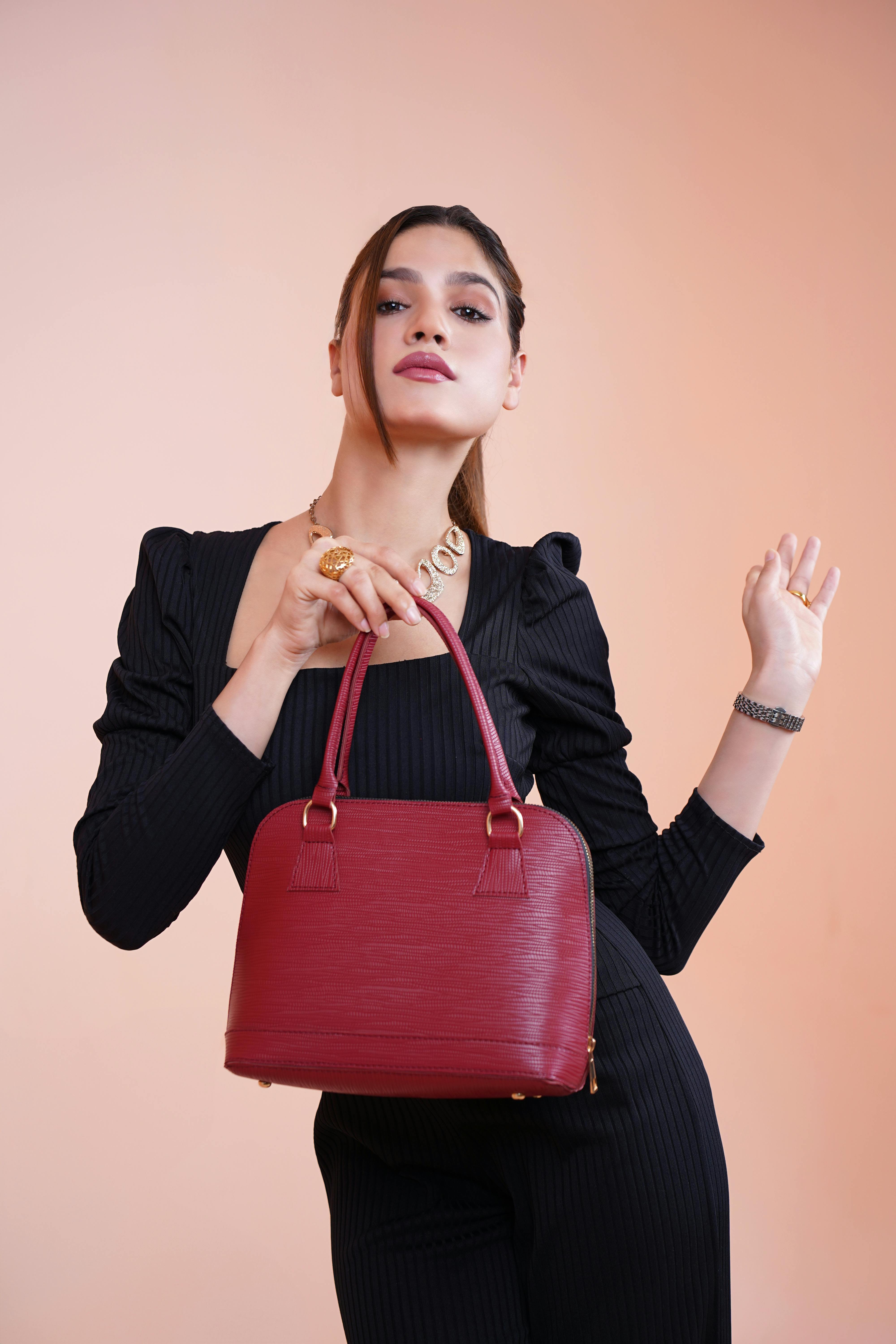 woman in black dress and with bag