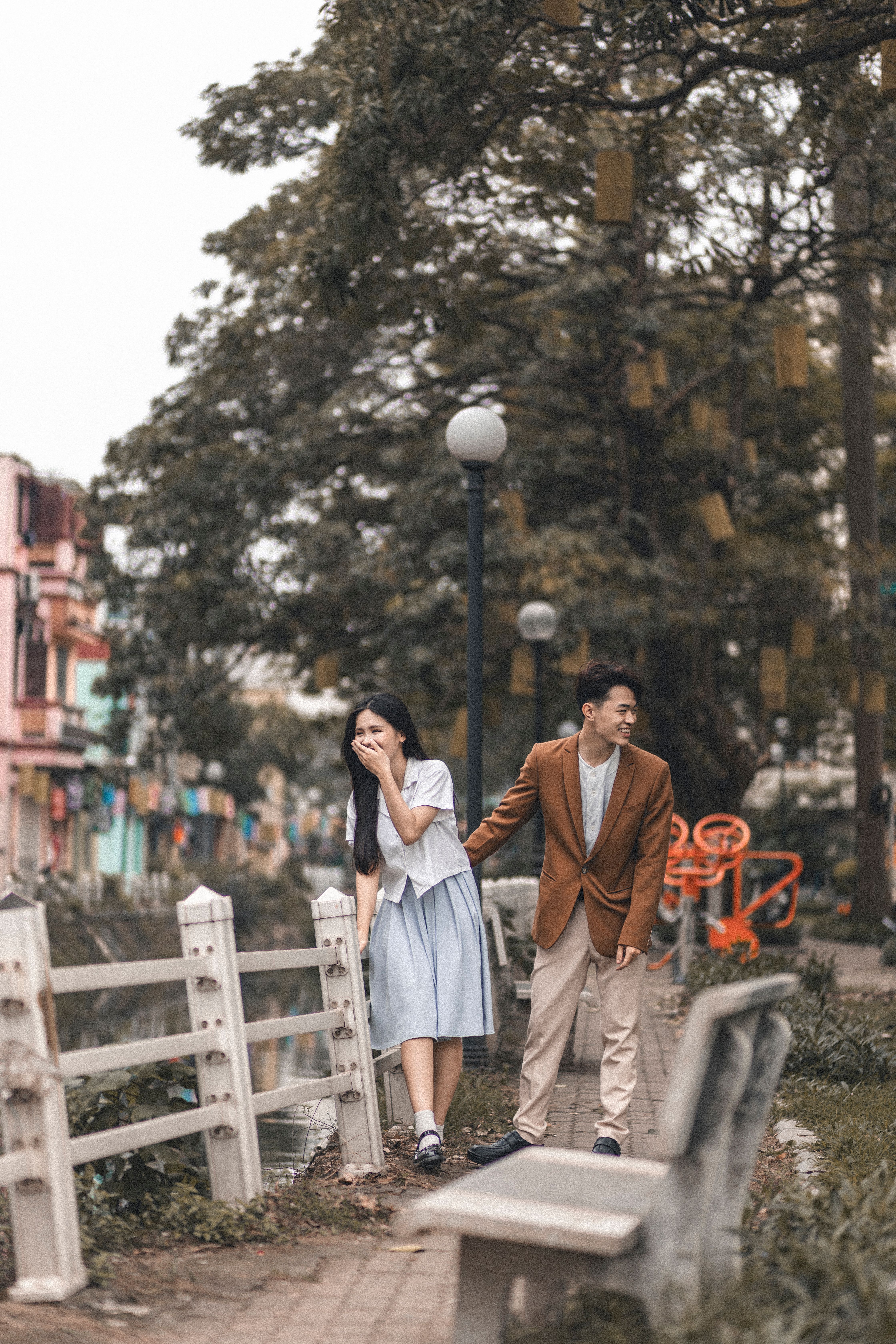 Couple walking in an urban park - illustrative stock photo