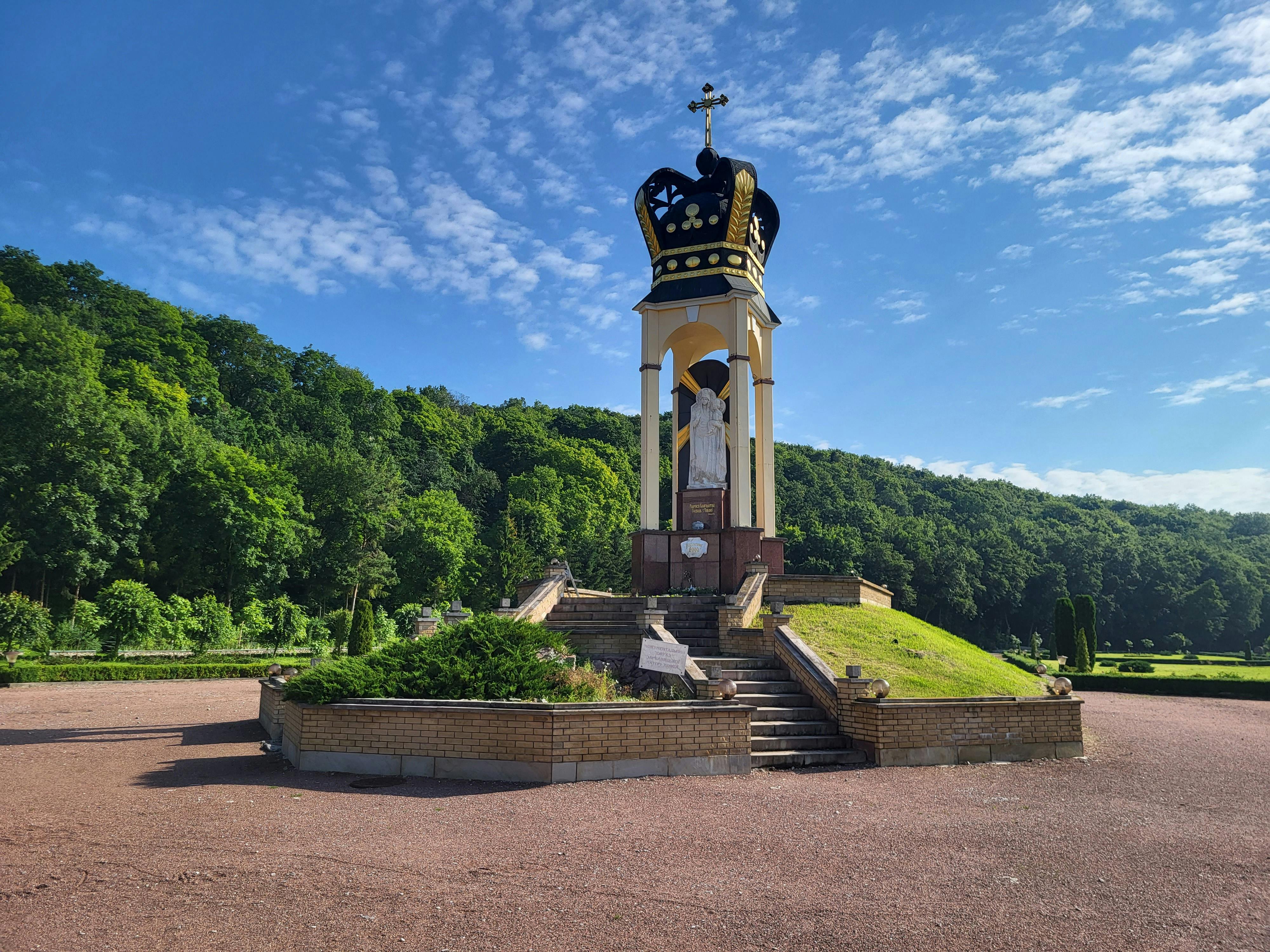 A striking monument set against a lush forest, captured in Zarvanytsia, Ukraine.