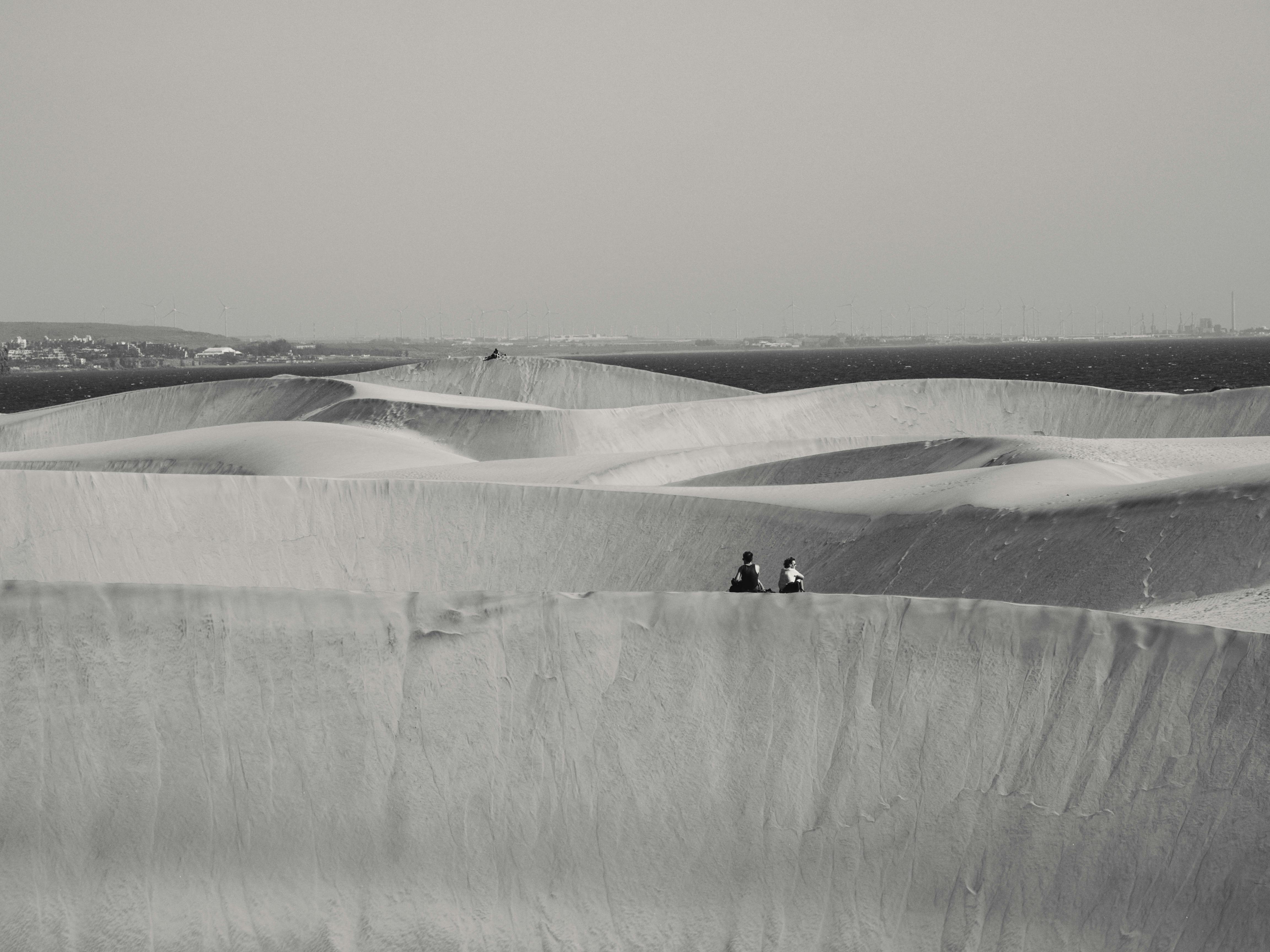 Discover the tranquil beauty of dunes in Las Palmas, captured in black and white with detailed textures.