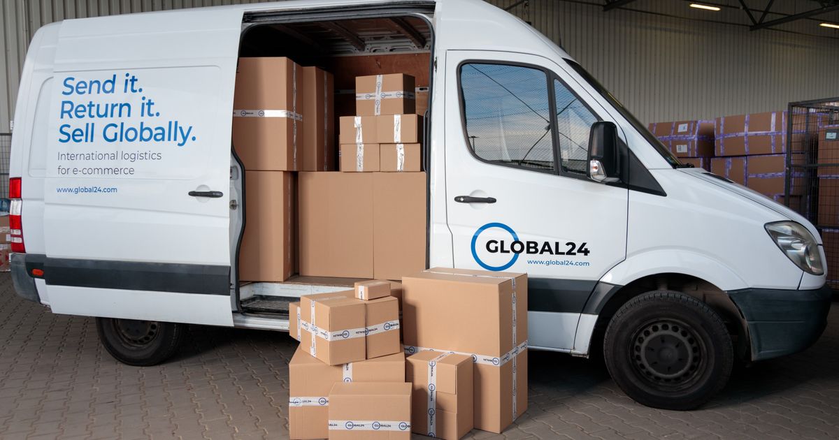 Cardboard boxes loaded in a delivery truck at a warehouse.