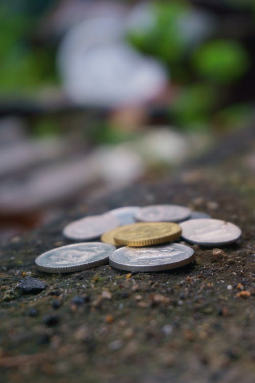 Round Silver-colored Coins on Ground