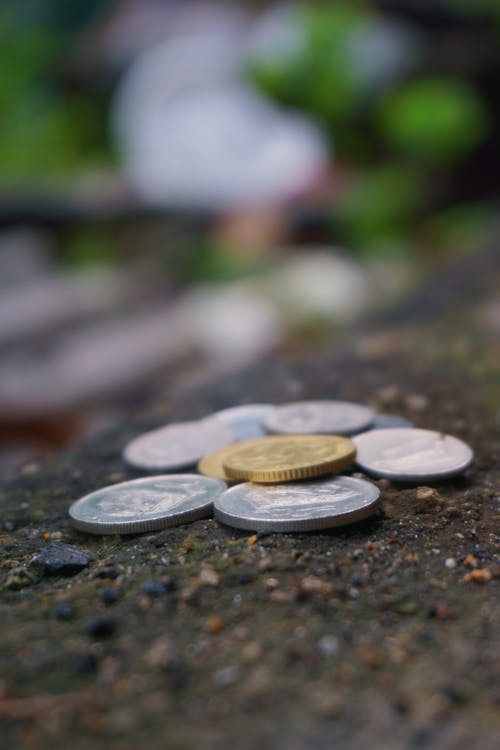 Free Round Silver-colored Coins on Ground Stock Photo