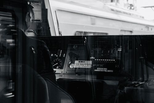 Free Monochrome image of a train driver's cockpit showing controls and reflections. Stock Photo