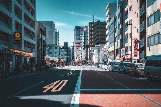 Dynamic city street with buildings and cars, capturing an urban vibe in Japan.