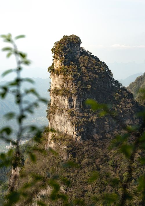 Free Breathtaking mountain peak surrounded by lush forest, captured in serene spring setting. Stock Photo