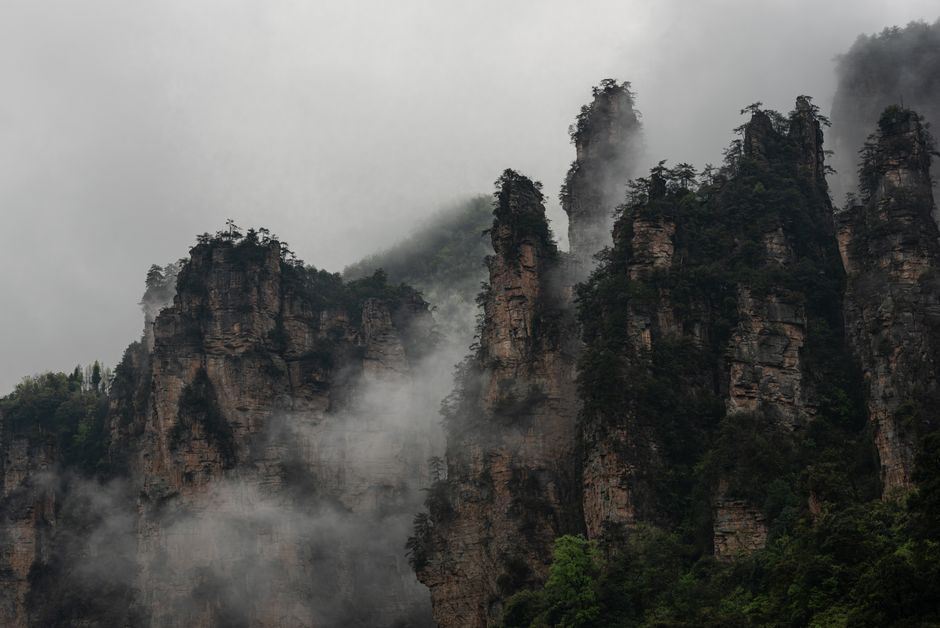 Hikers enjoying the scenic views of Zhangjiajie National Forest Park in China, representing adventure activities