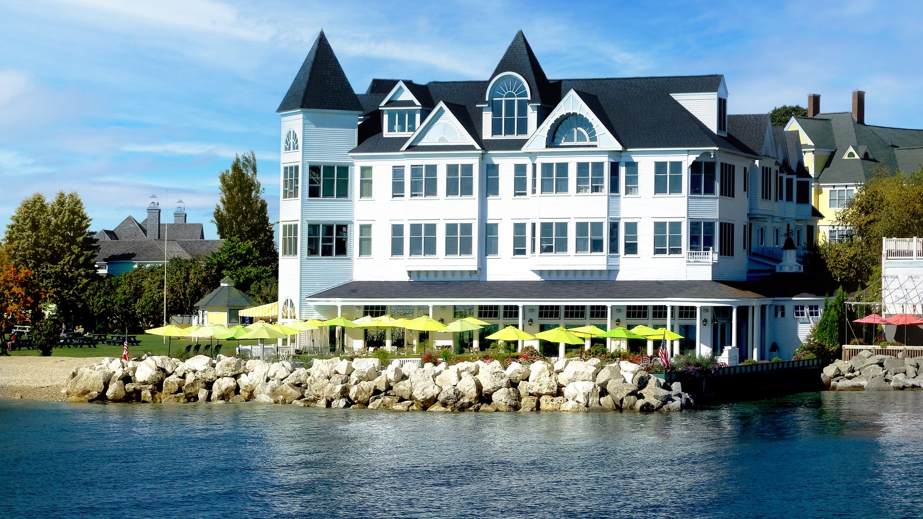 a classic Michigan lakeside inn with a long screened porch, rocking chairs, and Lake Michigan glowin