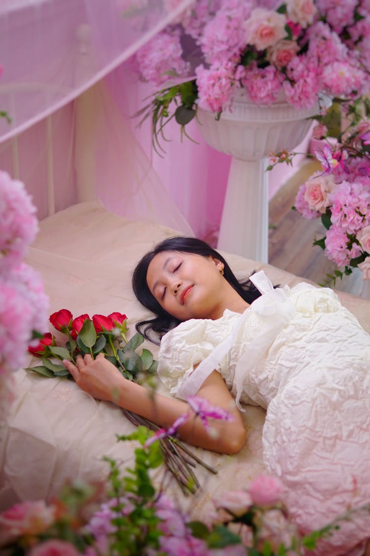 Beautiful Bride In Wedding Dress Sleeping Among Flowers