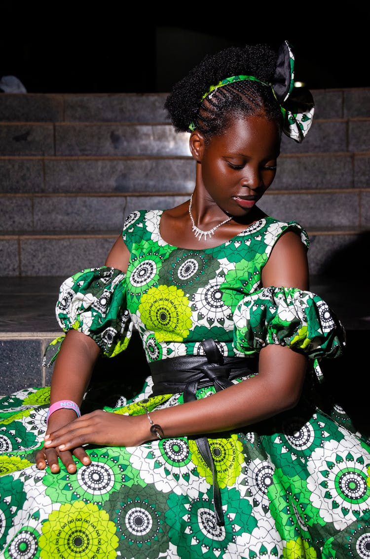 Beautiful Woman In Green Dress Posing On Stairs