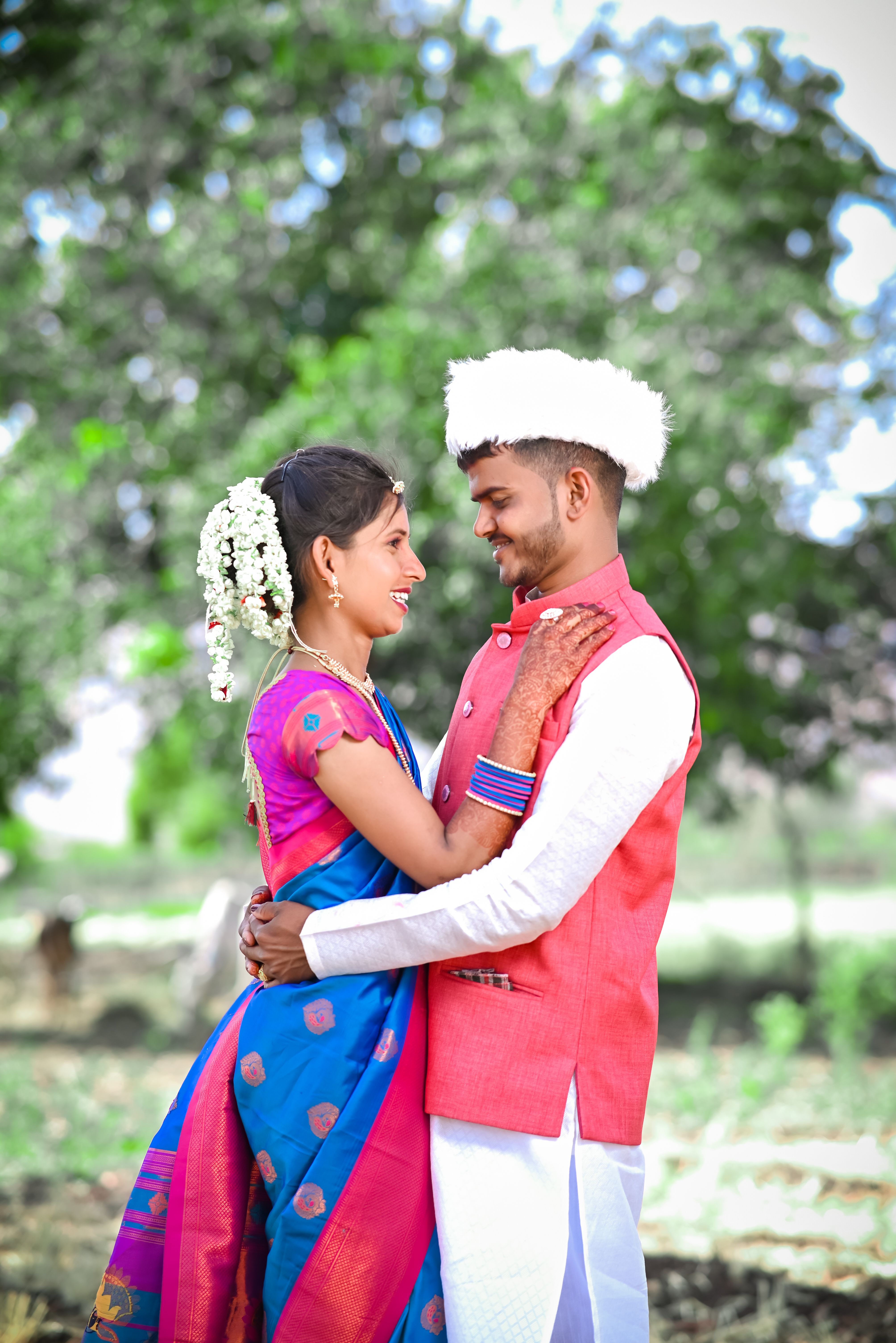 Smiling Couple Hugging in Traditional Clothing · Free Stock Photo